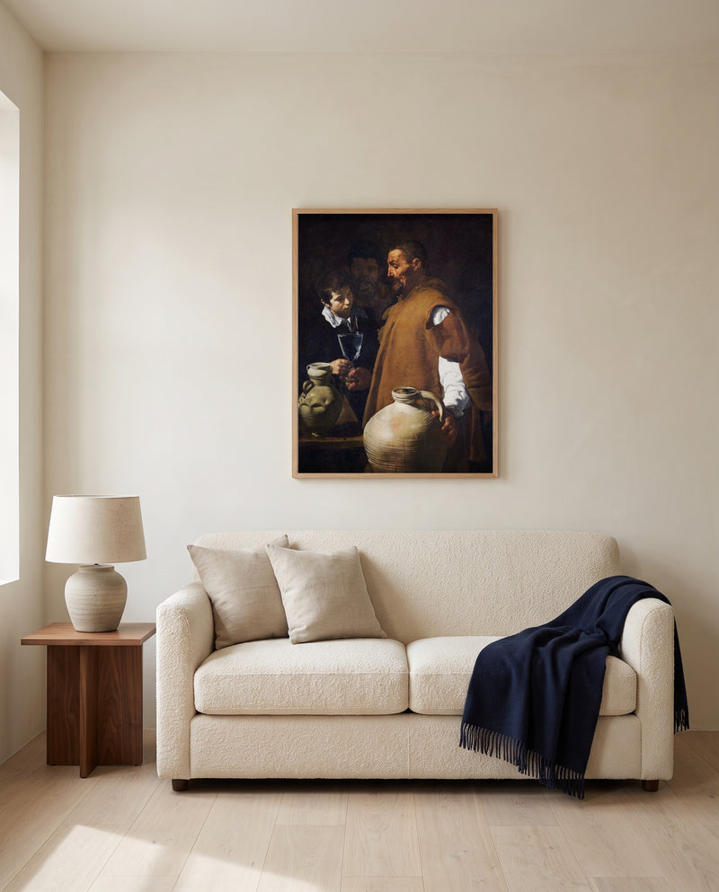 The Waterseller of Seville by Diego Velázquez framed in natural oak above a cream sofa in a warm living room