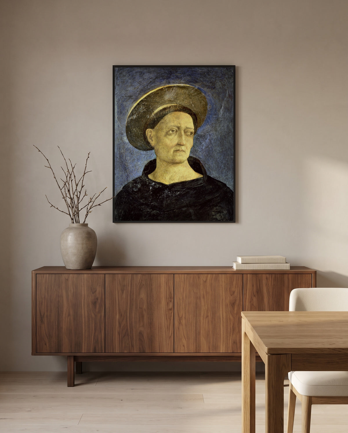Head of a Beardless Saint by Domenico Veneziano in a black frame above a walnut sideboard in a dining room