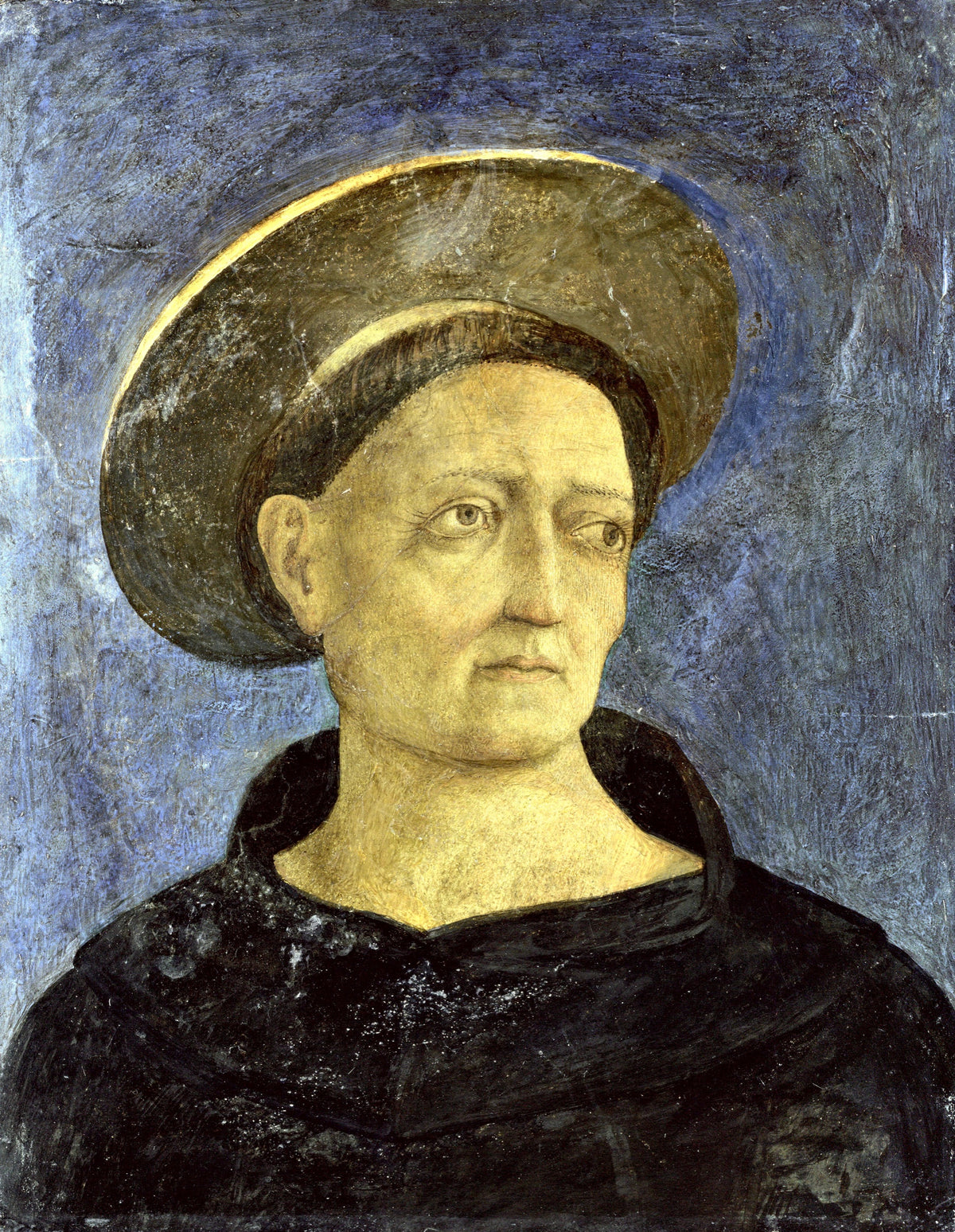 Head of a Beardless Saint by Domenico Veneziano: a friar in a dark robe with a gold halo tilted on his head, on blue