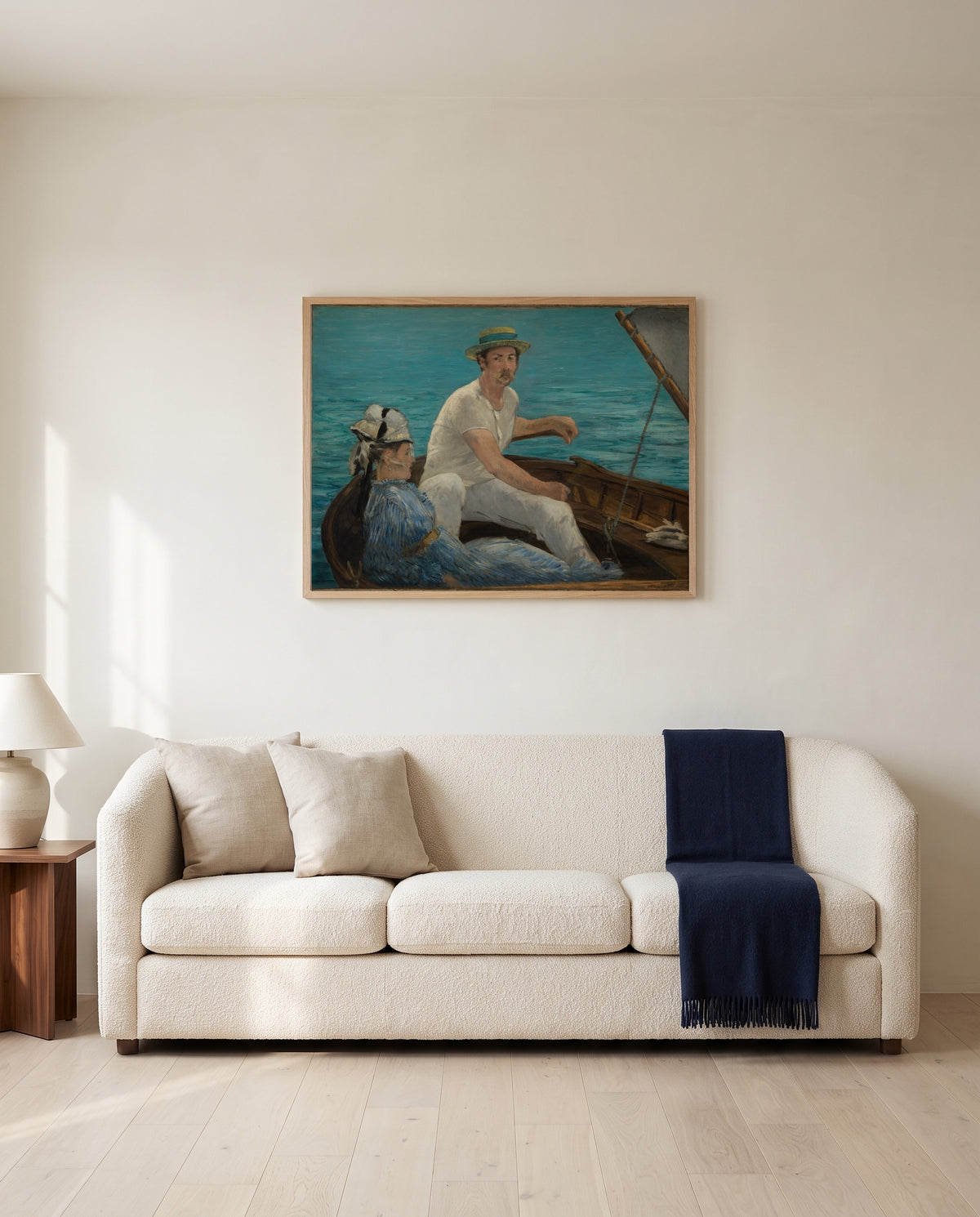 Boating by Édouard Manet framed in natural oak above a cream sofa in a warm living room