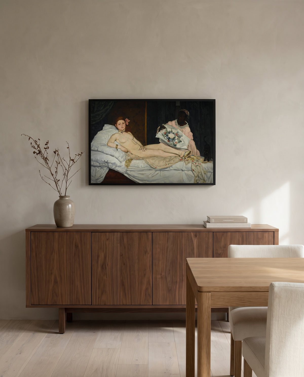 Olympia by Édouard Manet in a black frame above a walnut sideboard in a dining room
