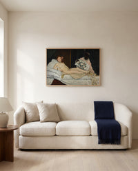 Olympia by Édouard Manet framed in natural oak above a cream sofa in a warm living room