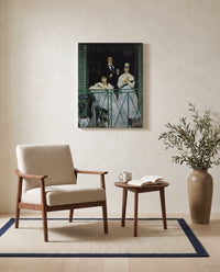 The Balcony by Édouard Manet as a stretched canvas above a linen lounge chair in a reading corner