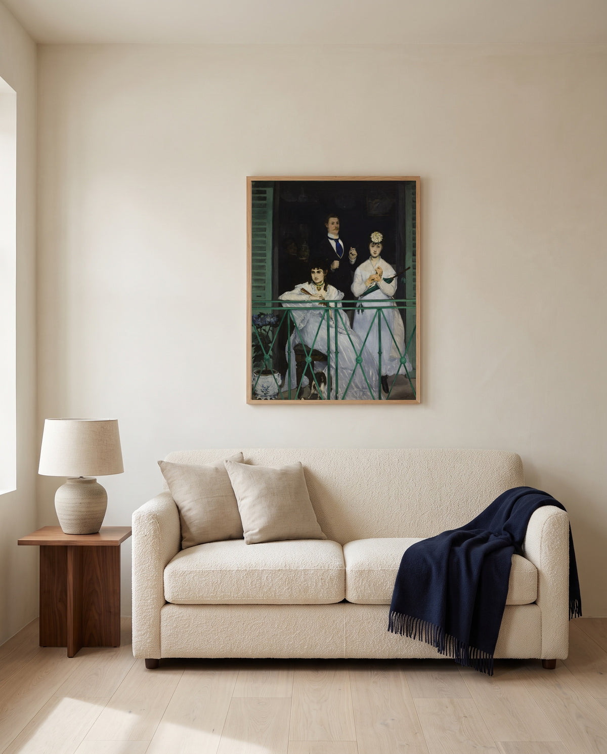 The Balcony by Édouard Manet framed in natural oak above a cream sofa in a warm living room