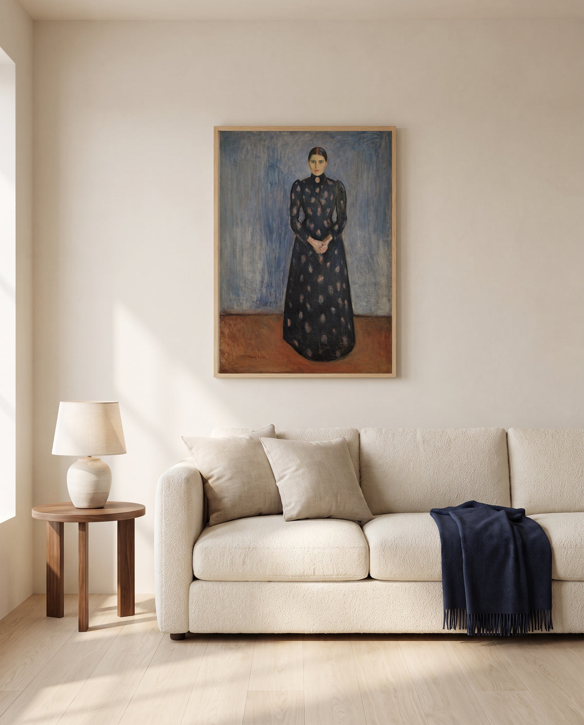 Inger in Black and Violet by Edvard Munch framed in natural oak above a cream sofa in a warm living room