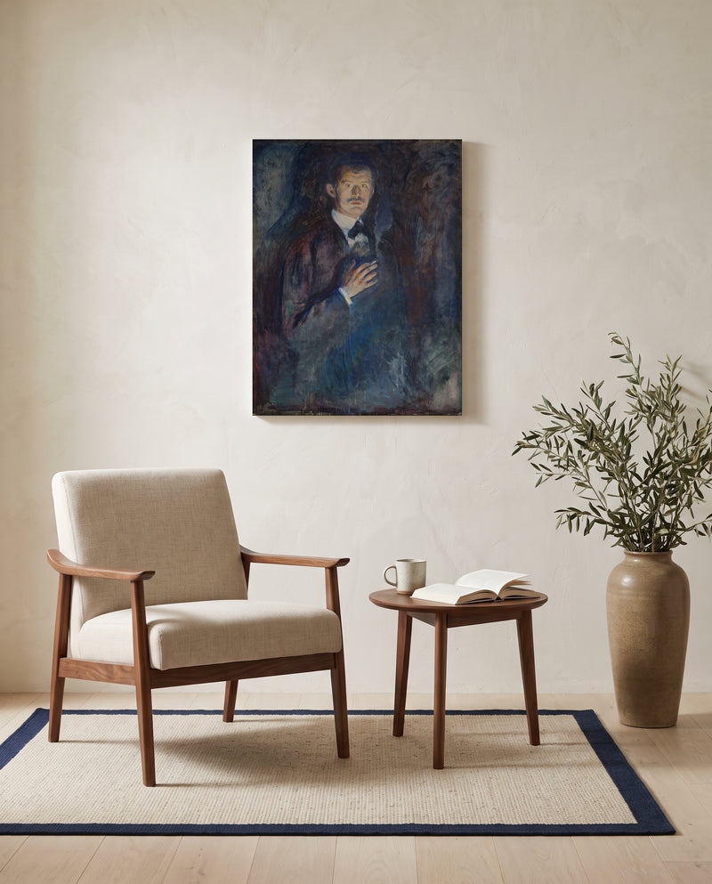Self-Portrait with Cigarette by Edvard Munch as a stretched canvas above a linen lounge chair in a reading corner