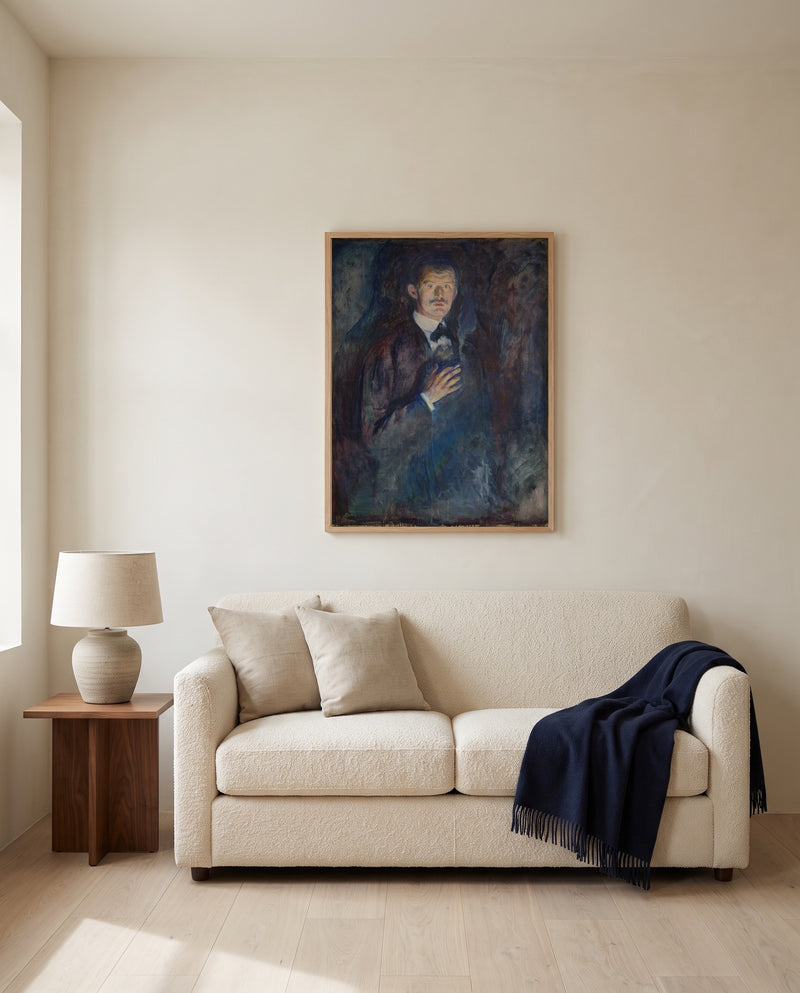 Self-Portrait with Cigarette by Edvard Munch framed in natural oak above a cream sofa in a warm living room