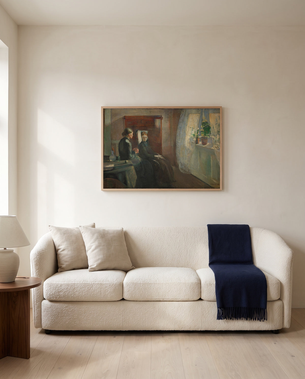 Spring by Edvard Munch framed in natural oak above a cream sofa in a warm living room