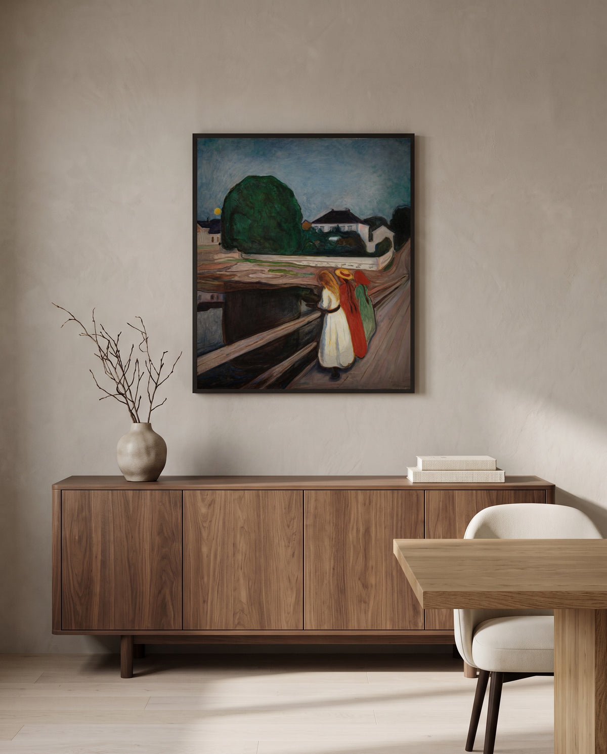 The Girls on the Bridge by Edvard Munch in a black frame above a walnut sideboard in a dining room