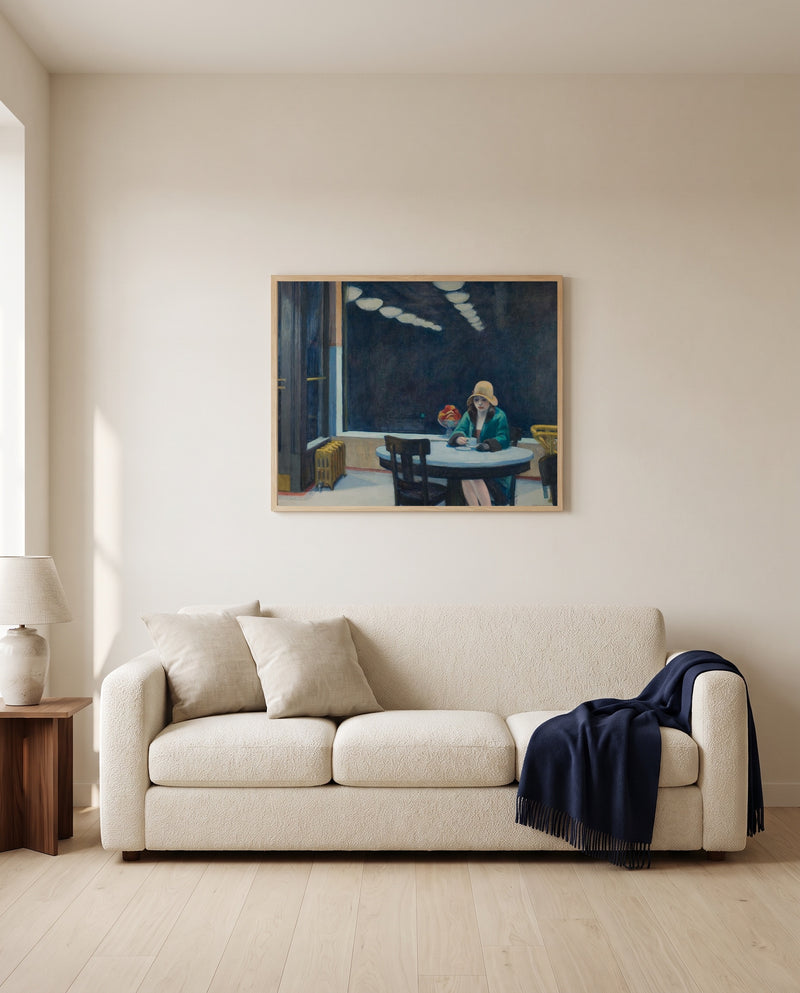 Automat by Edward Hopper framed in natural oak above a cream sofa in a warm living room