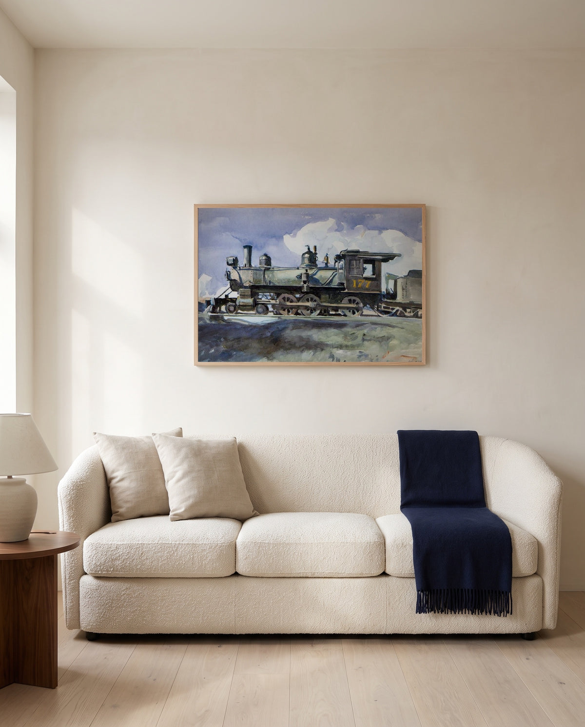 D. & R.G. Locomotive by Edward Hopper framed in natural oak above a cream sofa in a warm living room