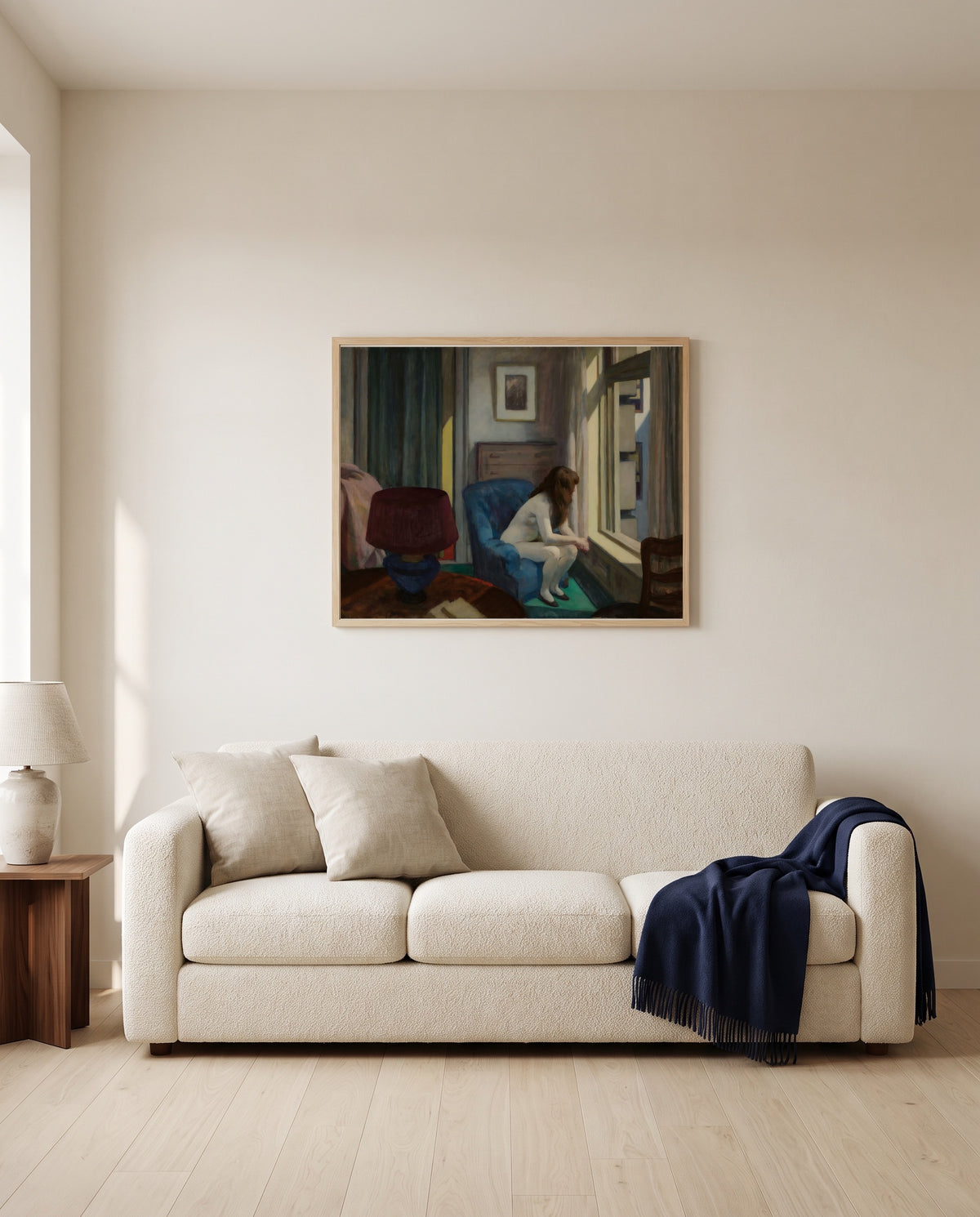 Eleven A.M. by Edward Hopper framed in natural oak above a cream sofa in a warm living room