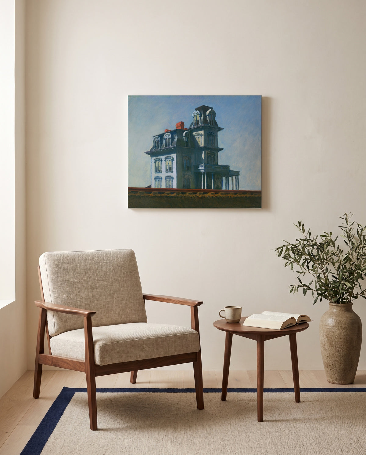 House by the Railroad by Edward Hopper as a stretched canvas above a linen lounge chair in a reading corner