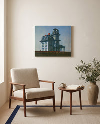 House by the Railroad by Edward Hopper as a stretched canvas above a linen lounge chair in a reading corner