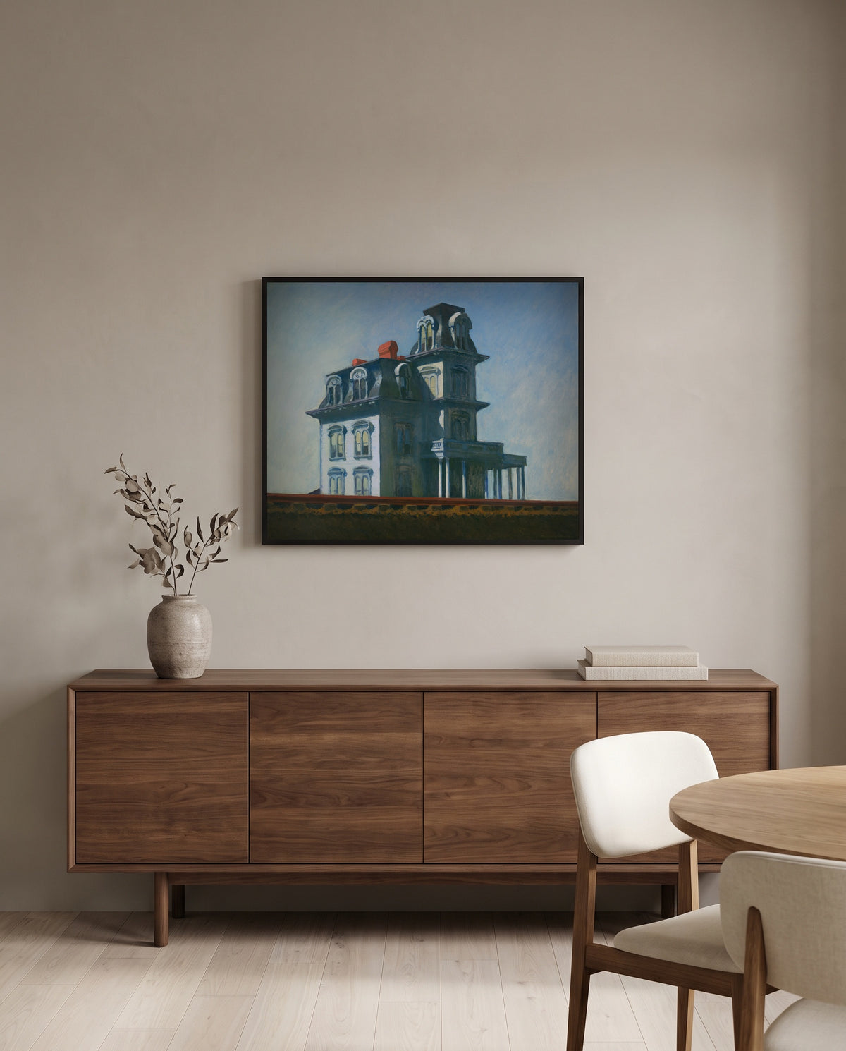 House by the Railroad by Edward Hopper in a black frame above a walnut sideboard in a dining room