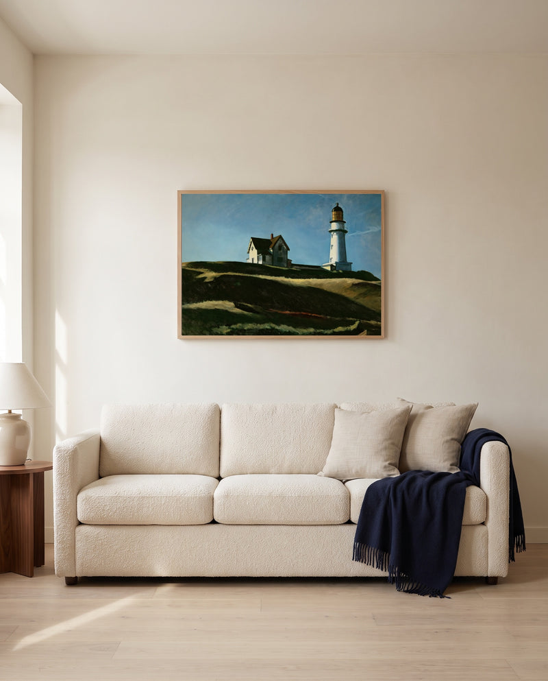 Lighthouse Hill by Edward Hopper framed in natural oak above a cream sofa in a warm living room