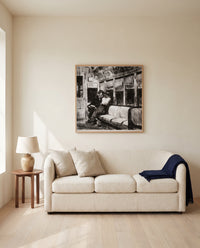 Night on the El Train by Edward Hopper framed in natural oak above a cream sofa in a warm living room