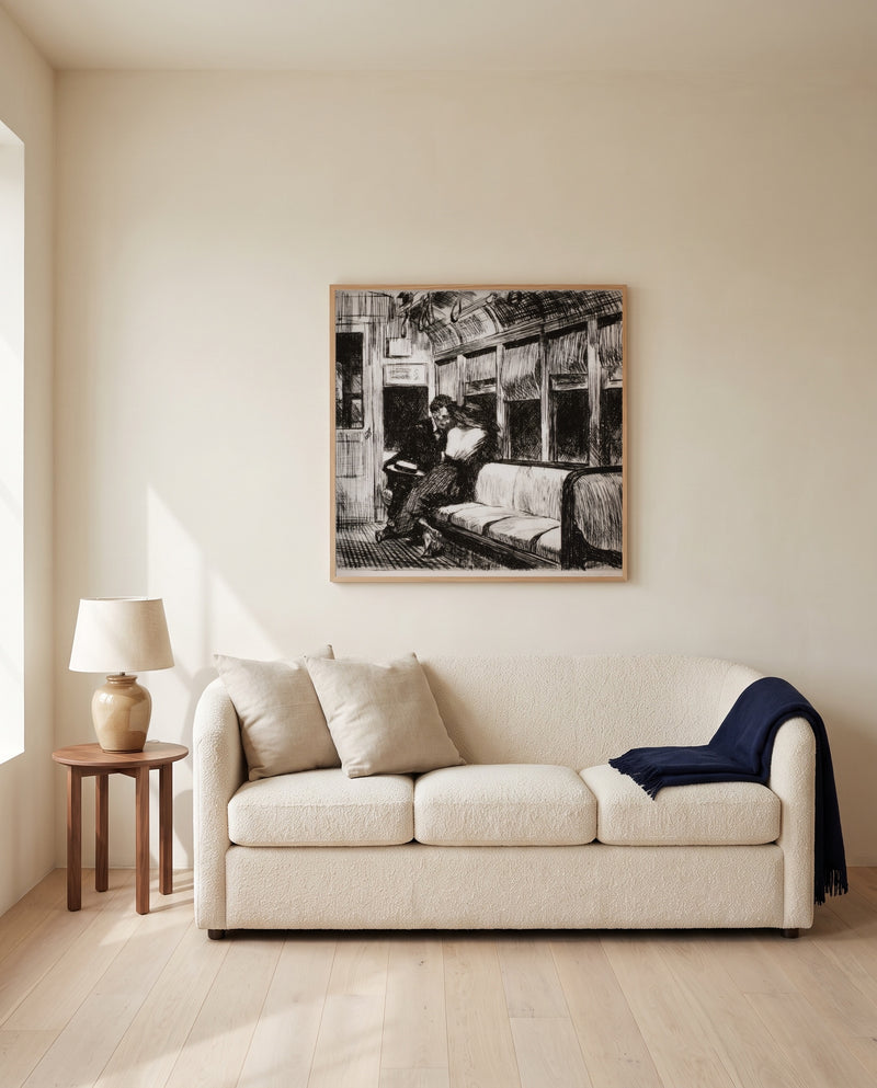 Night on the El Train by Edward Hopper framed in natural oak above a cream sofa in a warm living room
