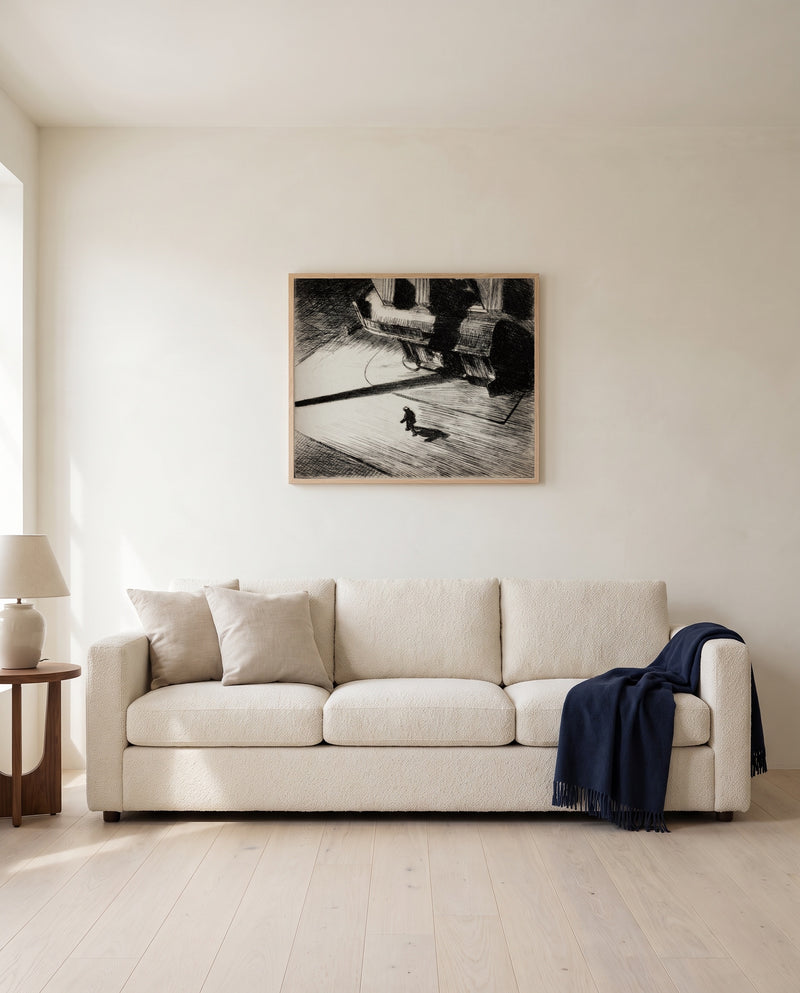 Night Shadows by Edward Hopper framed in natural oak above a cream sofa in a warm living room