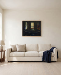 Night Windows by Edward Hopper framed in natural oak above a cream sofa in a warm living room