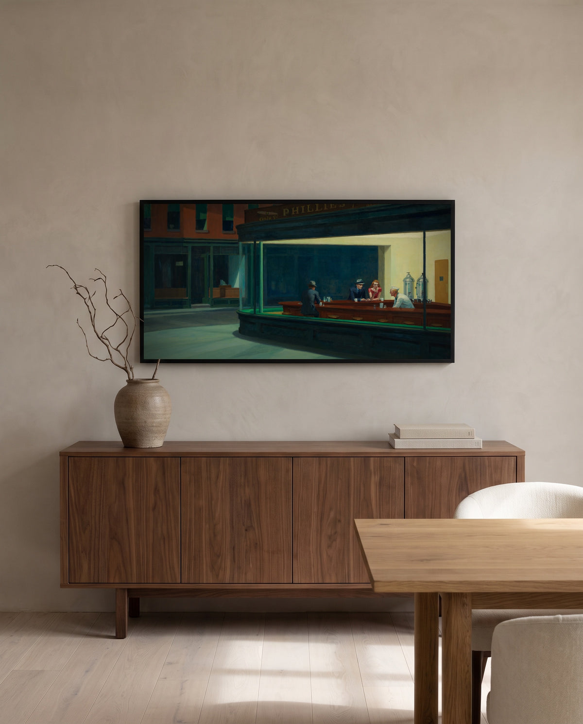 Nighthawks by Edward Hopper in a black frame above a walnut sideboard in a dining room
