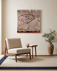 Autumn Tree in Stirred Air by Egon Schiele as a stretched canvas above a linen lounge chair in a reading corner