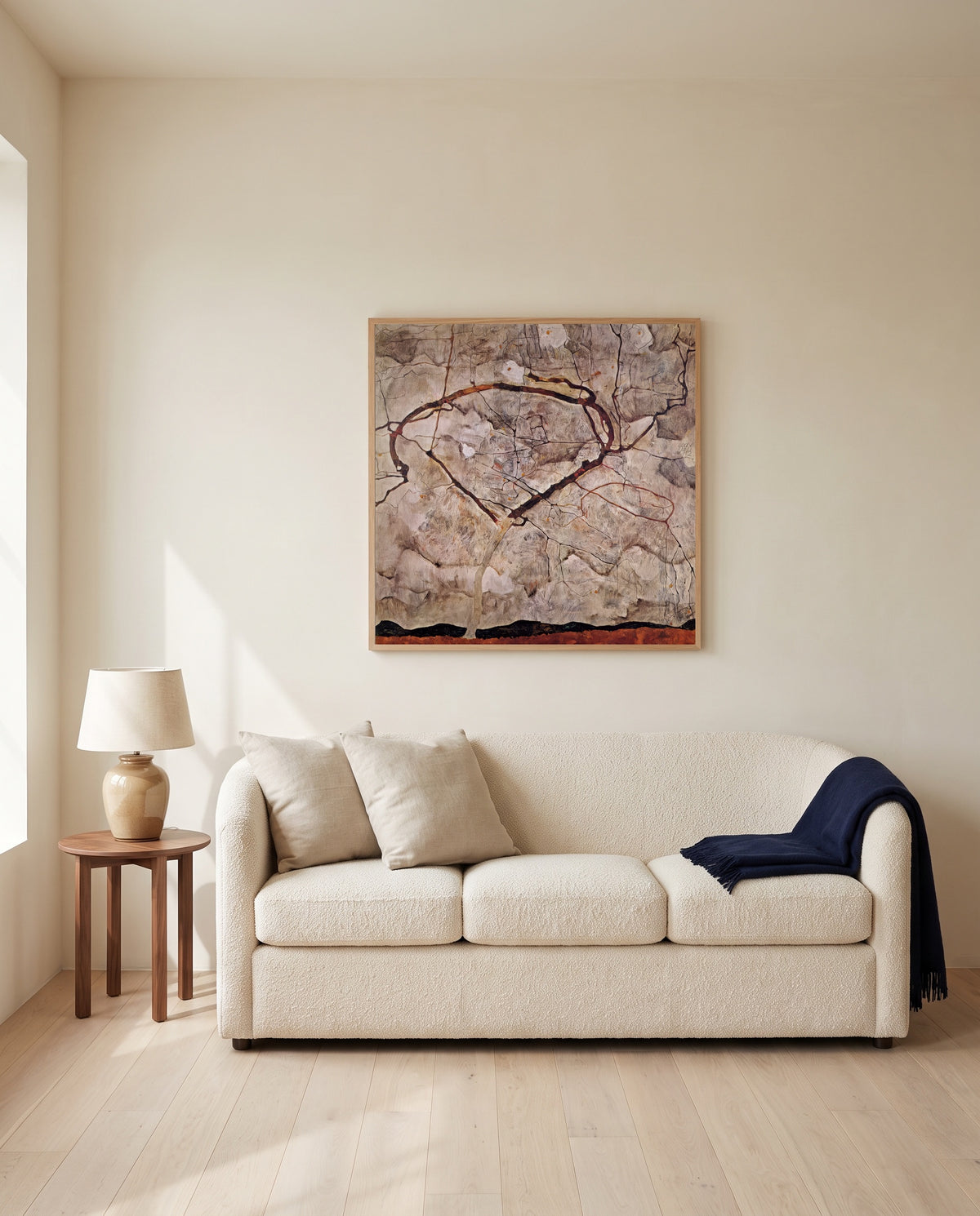 Autumn Tree in Stirred Air by Egon Schiele framed in natural oak above a cream sofa in a warm living room