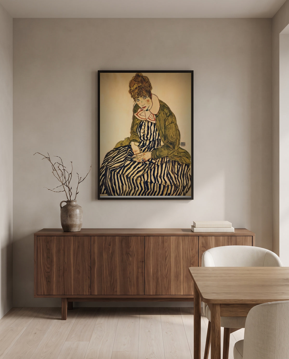 Edith in a Striped Dress by Egon Schiele in a black frame above a walnut sideboard in a dining room