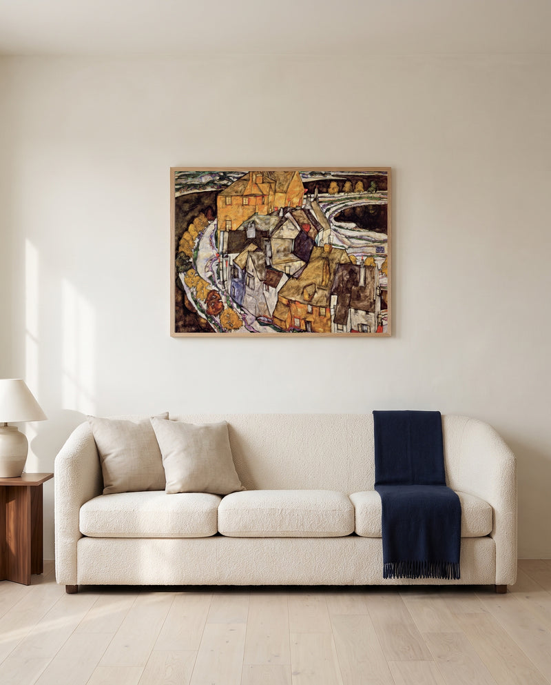 Island Town by Egon Schiele framed in natural oak above a cream sofa in a warm living room