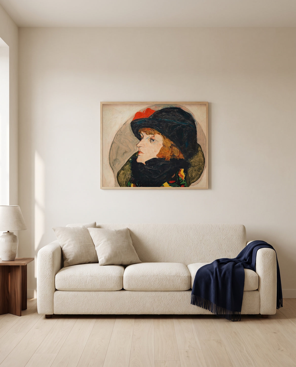 Portrait of Ida Roessler by Egon Schiele framed in natural oak above a cream sofa in a warm living room