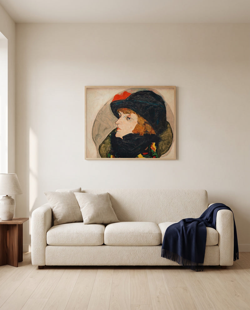 Portrait of Ida Roessler by Egon Schiele framed in natural oak above a cream sofa in a warm living room