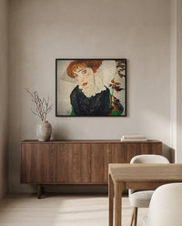 Portrait of Wally by Egon Schiele in a black frame above a walnut sideboard in a dining room