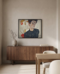 Self-Portrait with Physalis by Egon Schiele in a black frame above a walnut sideboard in a dining room