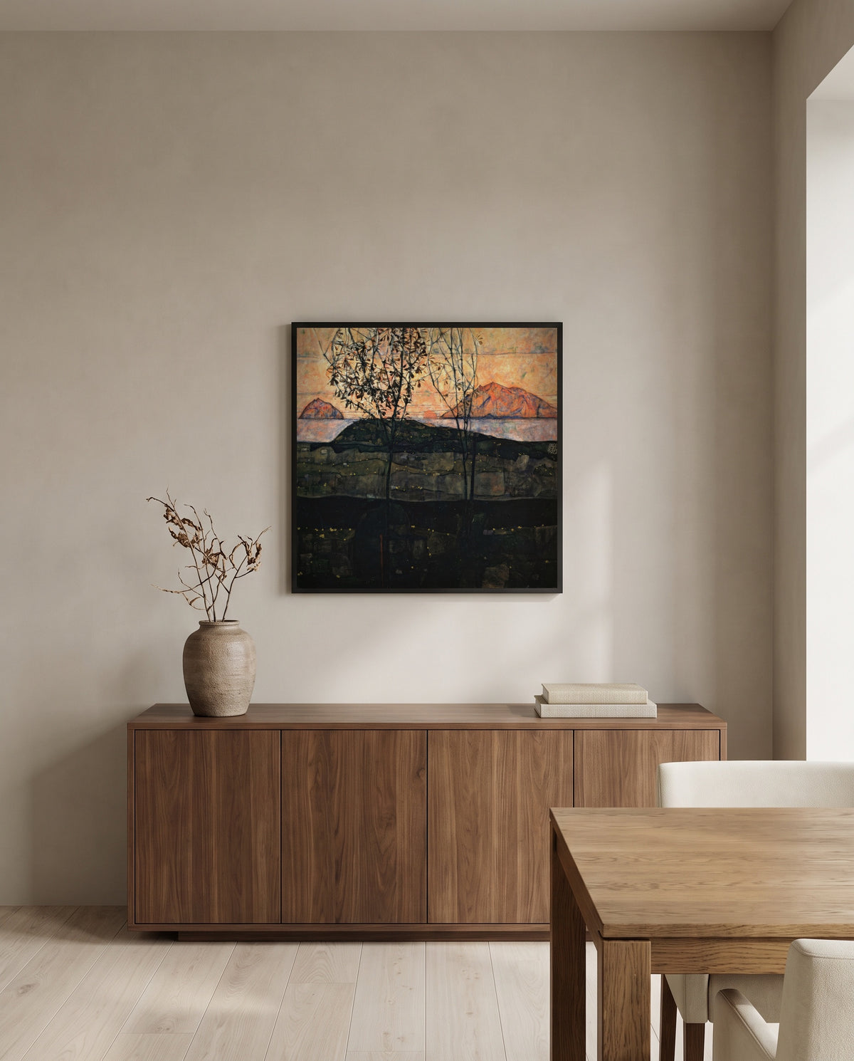 Setting Sun by Egon Schiele in a black frame above a walnut sideboard in a dining room