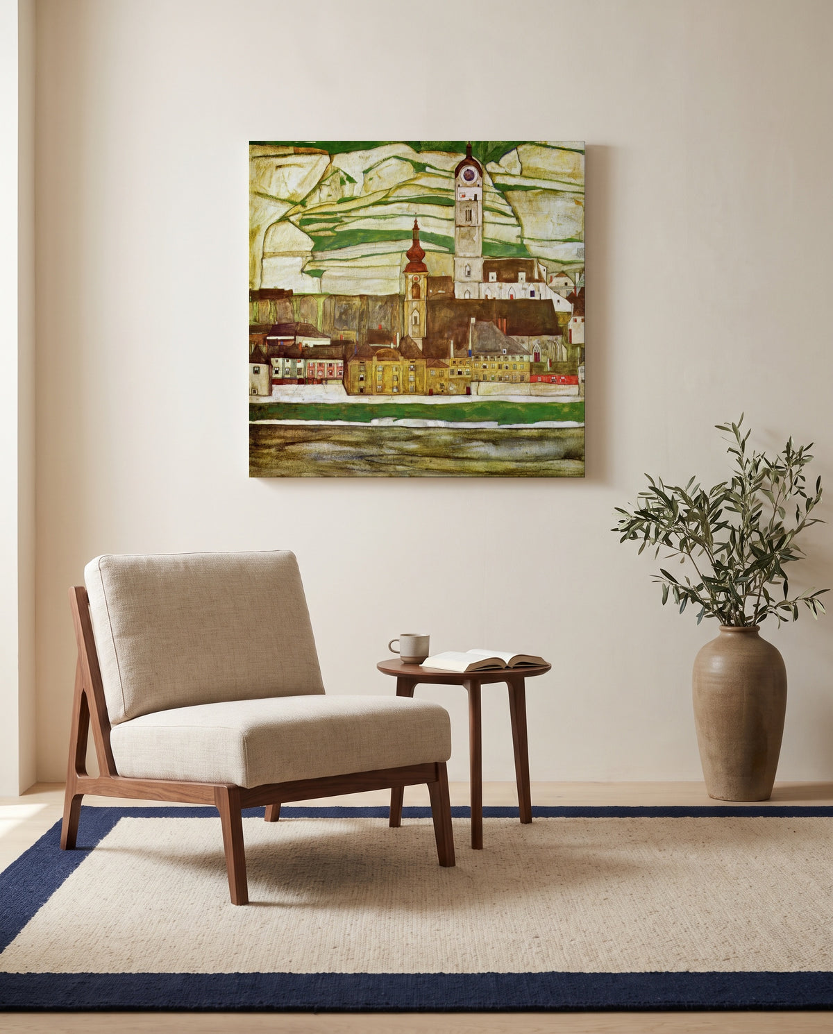 Stein on the Danube by Egon Schiele as a stretched canvas above a linen lounge chair in a reading corner