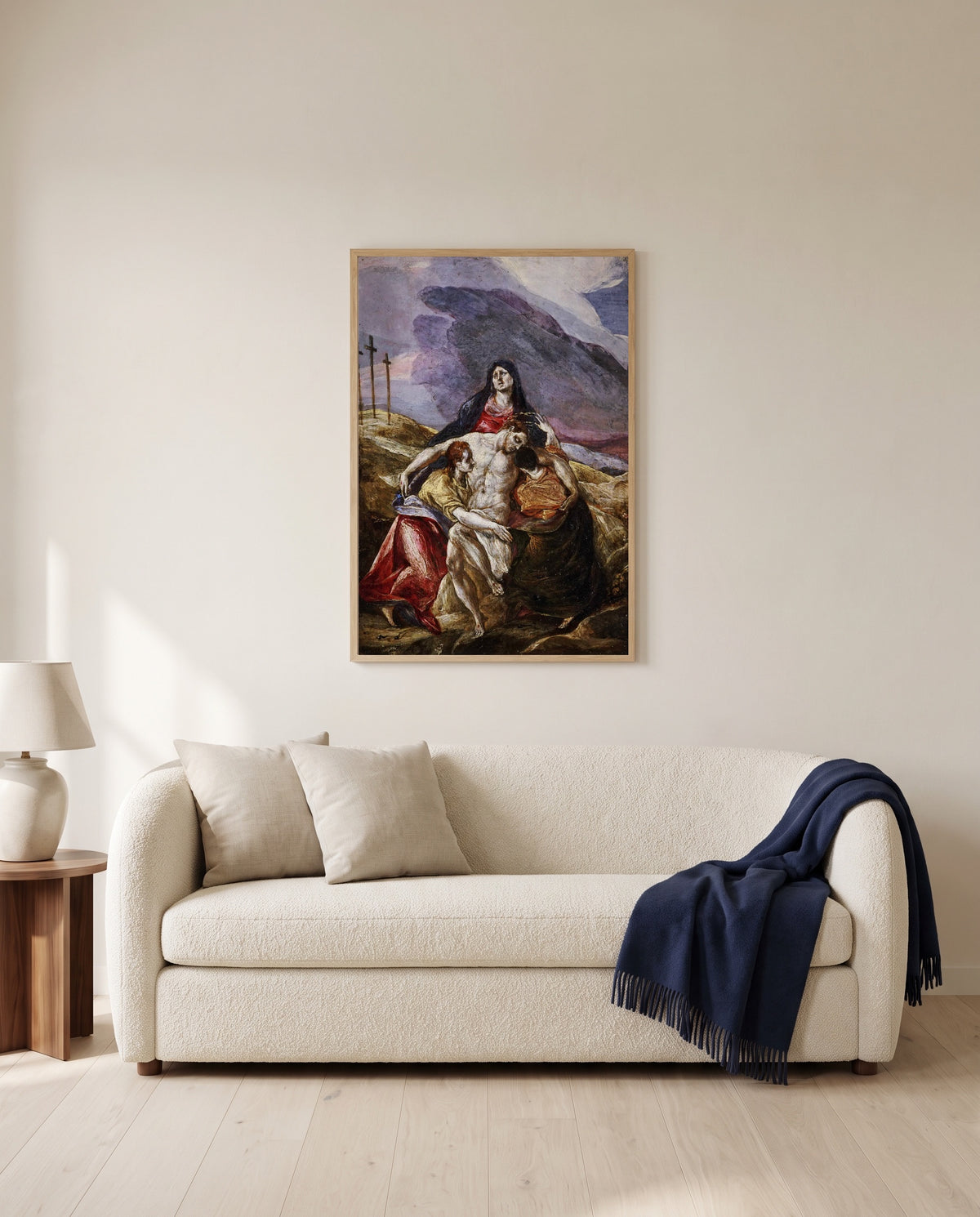 Lamentation by El Greco framed in natural oak above a cream sofa in a warm living room