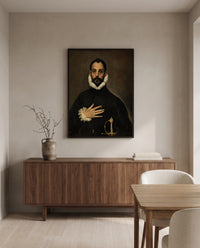 Nobleman, Hand on Chest by El Greco in a black frame above a walnut sideboard in a dining room