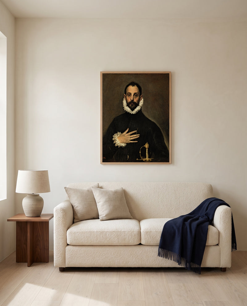 Nobleman, Hand on Chest by El Greco framed in natural oak above a cream sofa in a warm living room