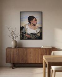 Orphan Girl at the Cemetery by Eugène Delacroix in a black frame above a walnut sideboard in a dining room