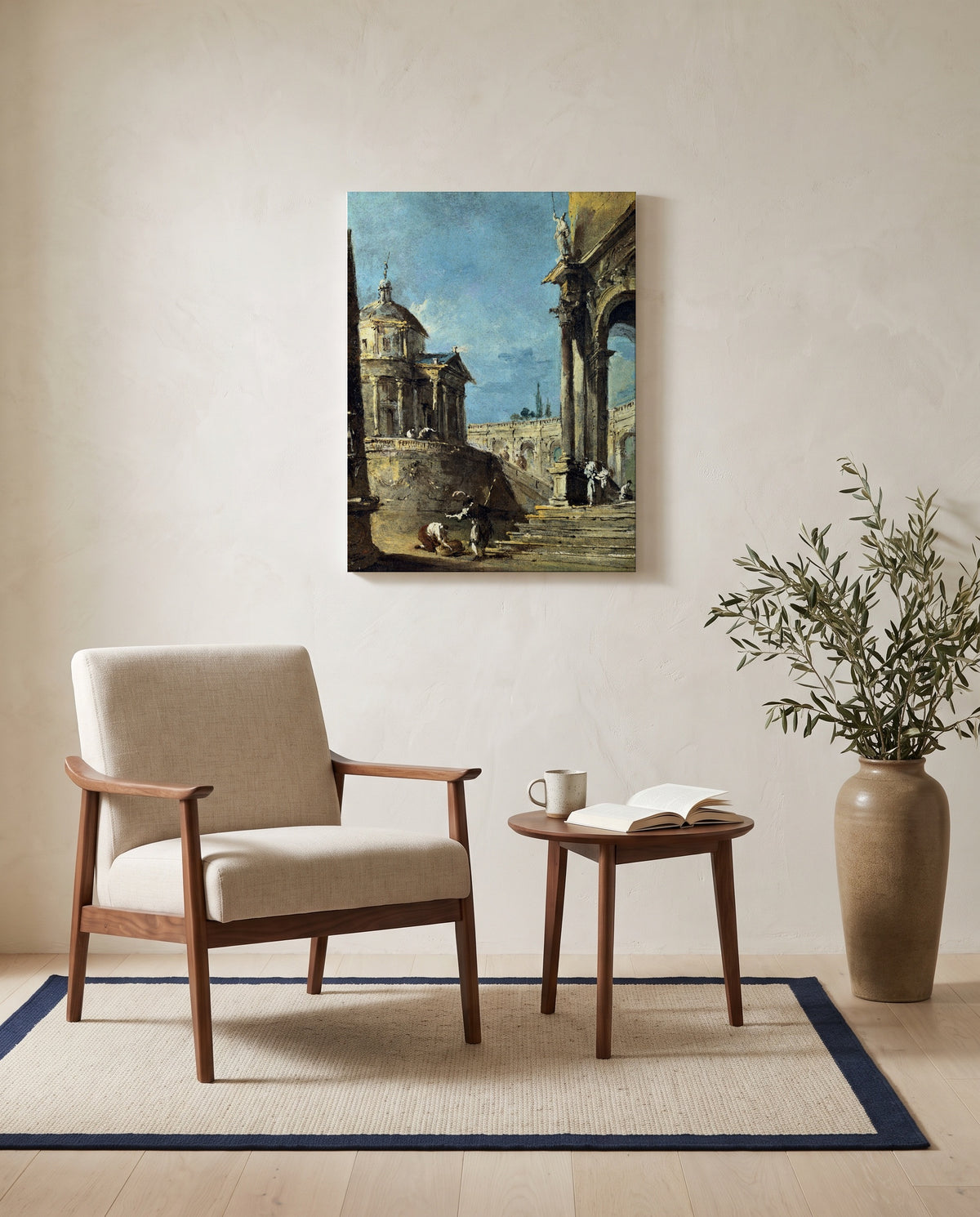 An Architectural Caprice by Francesco Guardi as a stretched canvas above a linen lounge chair in a reading corner