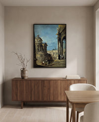 An Architectural Caprice by Francesco Guardi in a black frame above a walnut sideboard in a dining room