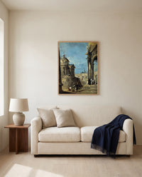 An Architectural Caprice by Francesco Guardi framed in natural oak above a cream sofa in a warm living room