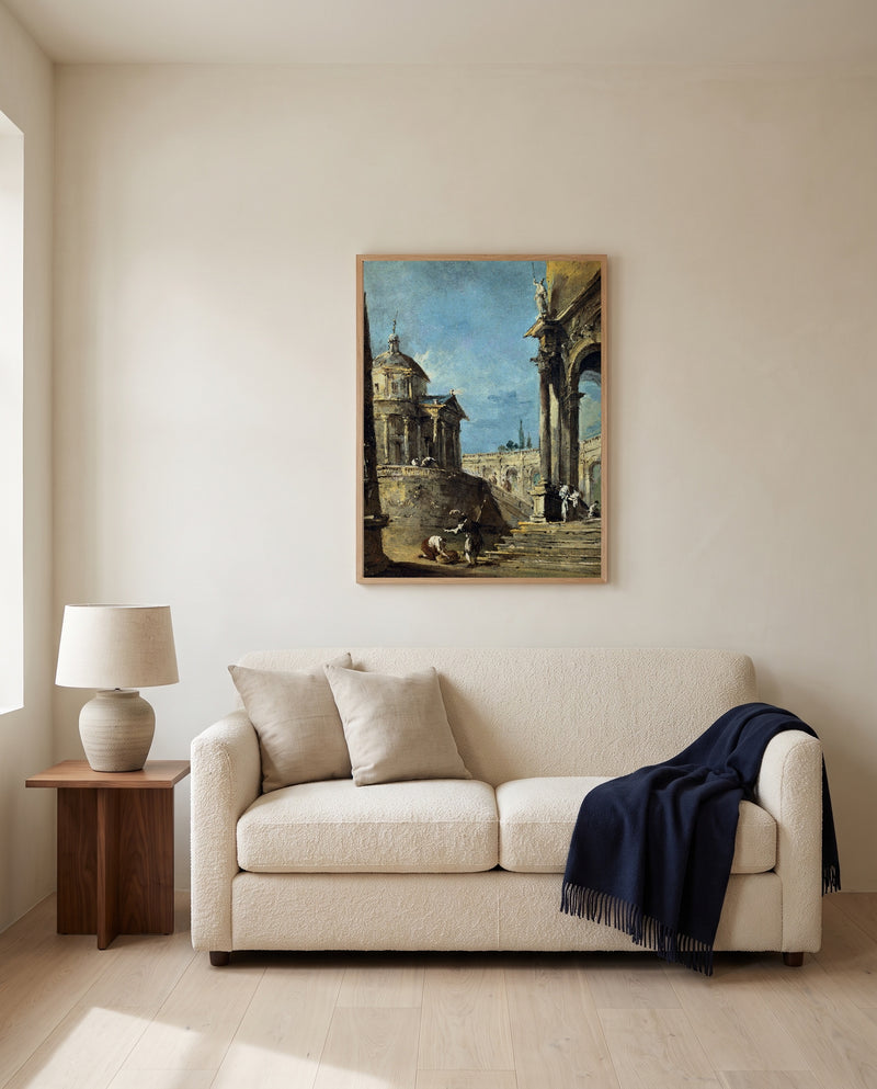 An Architectural Caprice by Francesco Guardi framed in natural oak above a cream sofa in a warm living room