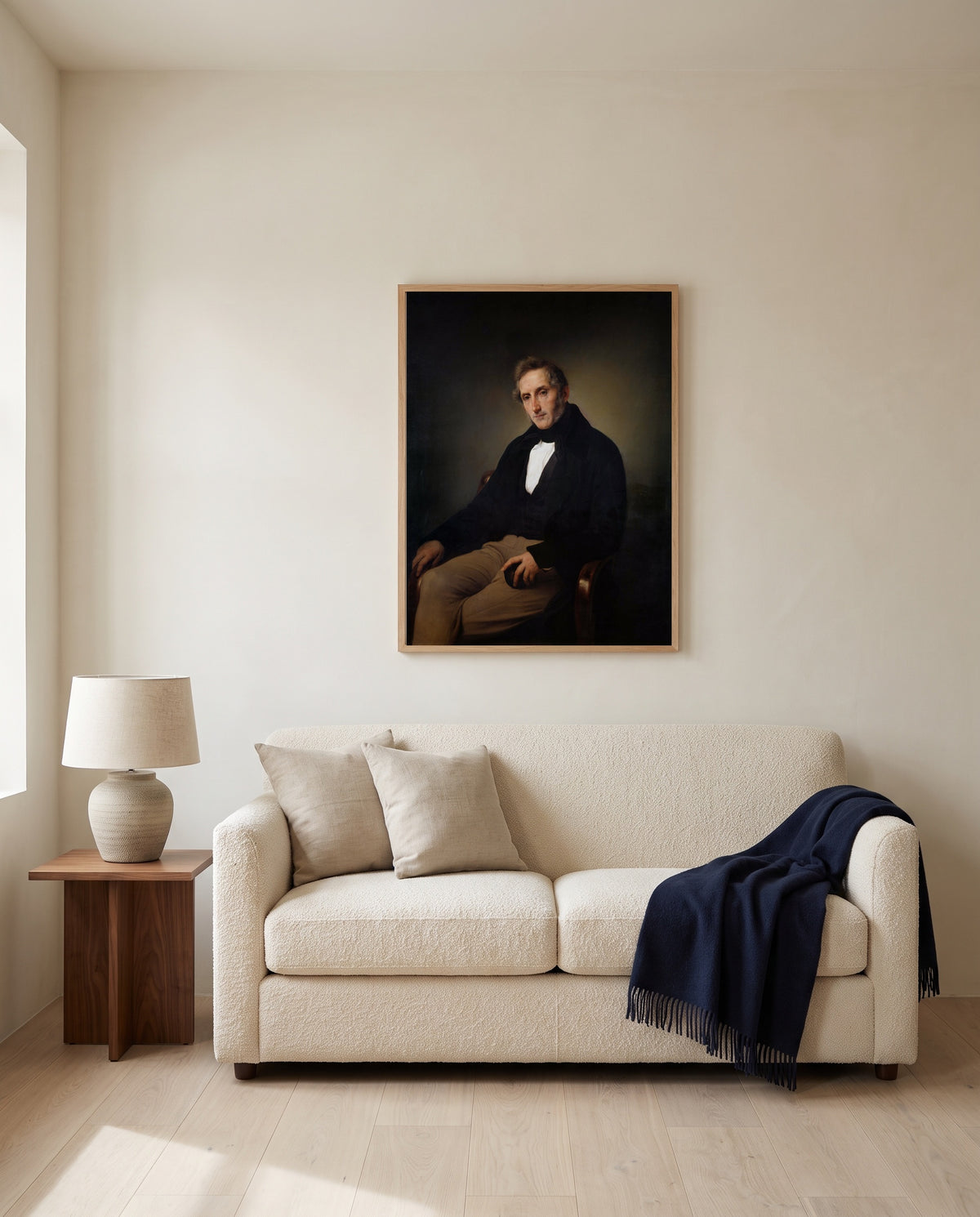 Alessandro Manzoni by Francesco Hayez framed in natural oak above a cream sofa in a warm living room