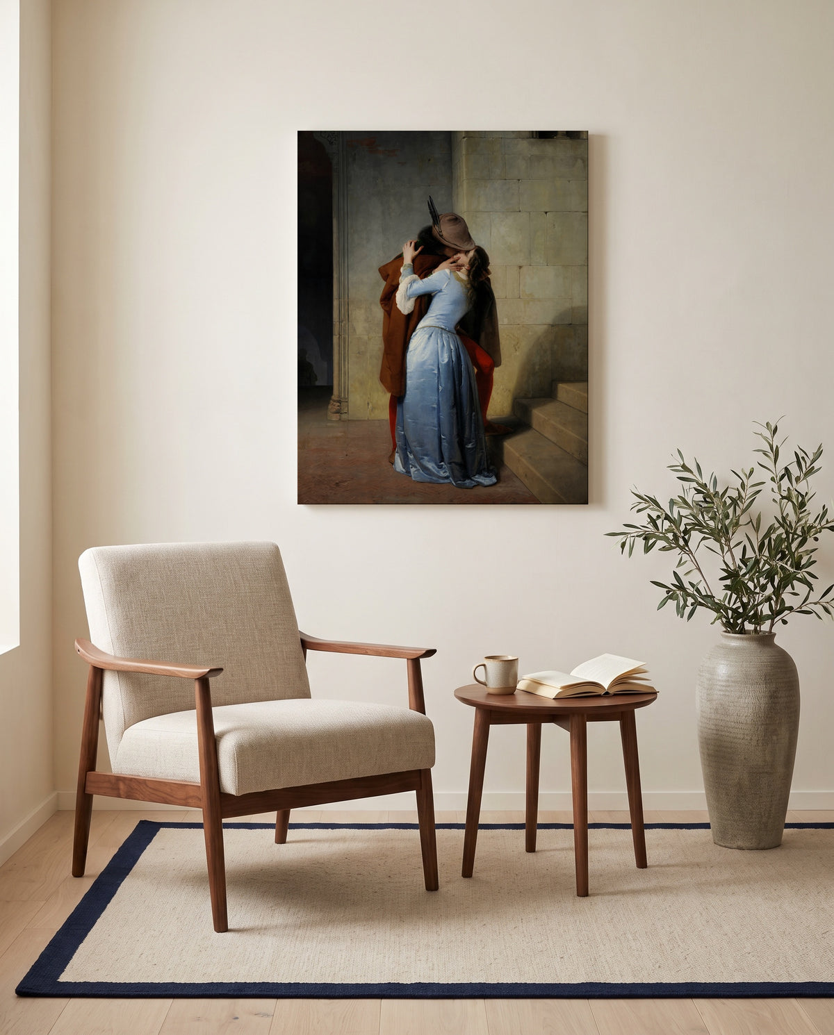 The Kiss by Francesco Hayez as a stretched canvas above a linen lounge chair in a reading corner