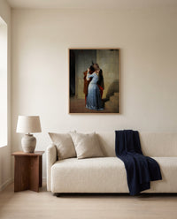The Kiss by Francesco Hayez framed in natural oak above a cream sofa in a warm living room