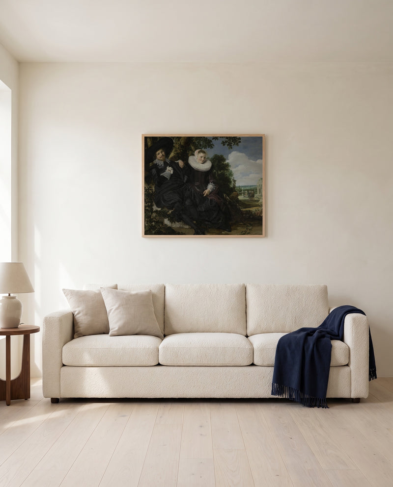 Isaac Massa and Beatrix by Frans Hals framed in natural oak above a cream sofa in a warm living room