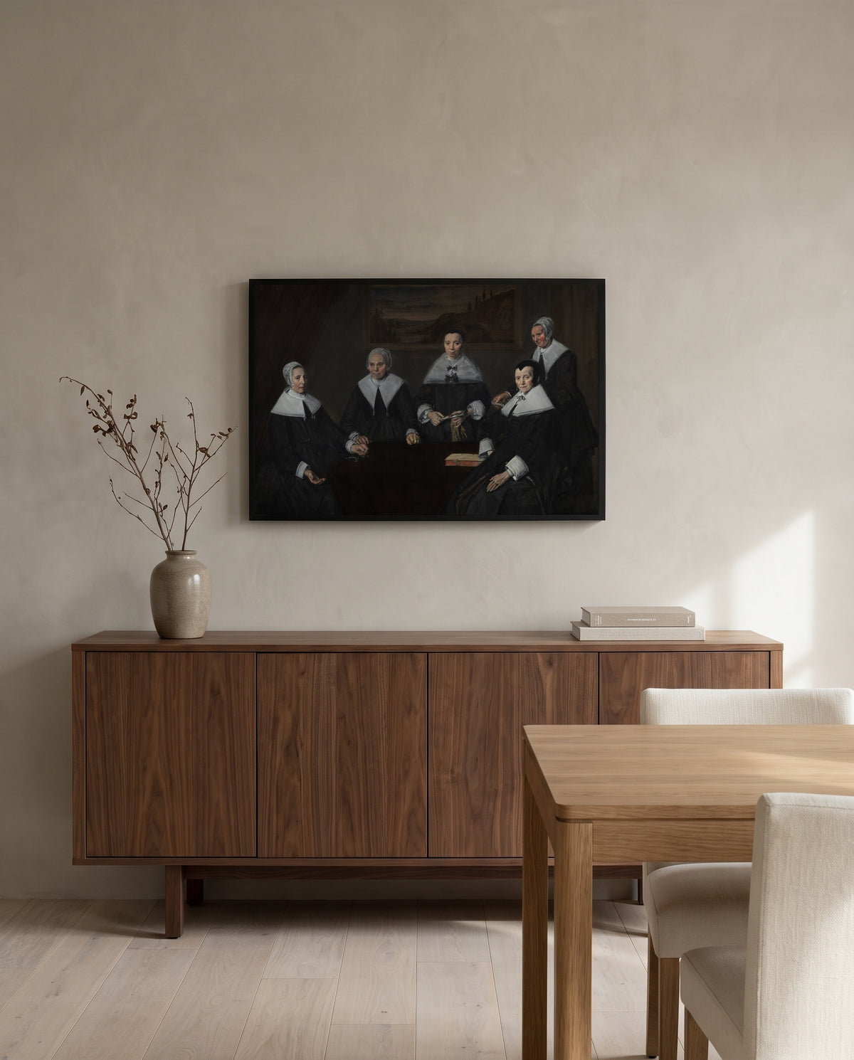 The Regentesses by Frans Hals in a black frame above a walnut sideboard in a dining room