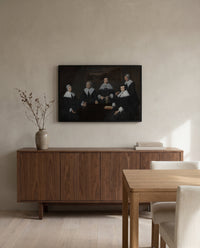 The Regentesses by Frans Hals in a black frame above a walnut sideboard in a dining room