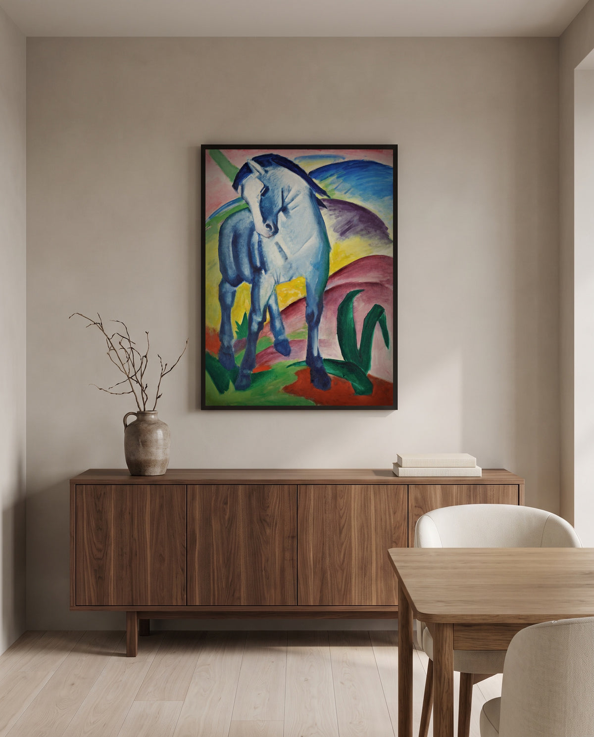 Blue Horse I by Franz Marc in a black frame above a walnut sideboard in a dining room